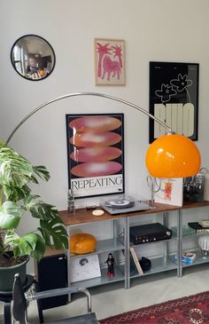 a living room filled with furniture and a large orange ball on top of a table