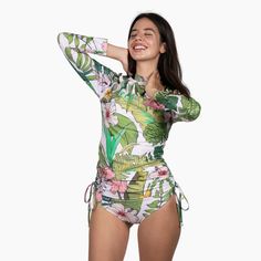 Stylish and protective, the Berry Jane Ruched Side Long Sleeve Swimsuit Rash Guard Set is perfect for active watersports. Fully lined with a built-in bra and removable pads. This beautiful Hawaiian floral print rash guard was made for days spent in the sun and at the beach. UPF 50 protection helps shield your skin from harmful rays, while the ruched sides provide a flattering fit. Whether you're hitting the beach or pool, this rash guard swimsuit is a must-have for your next adventure. Sale item White Fitted Rash Guard For Beach, Fitted White Rash Guard For Poolside, Fitted Tropical Nylon Swimwear, White Stretch Rash Guard For Beachwear, Summer Nylon Rash Guard For Swimming, Fitted Green Summer Rash Guard, Fitted Rash Guard For Beach Vacation, White Beachwear Rash Guard For Poolside, Fitted Summer Rash Guard For Swimming