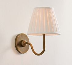 a wall light with a white shade on it