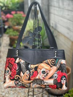 a handbag with an image of a woman's face and skull on it