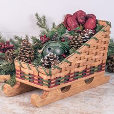 a wooden sleigh filled with pine cones and ornaments