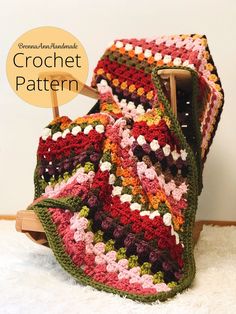 a crocheted blanket sitting on top of a wooden stand