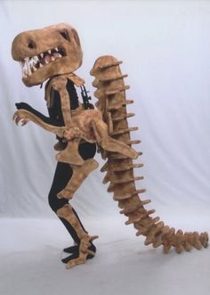 a dinosaur skeleton is posed in front of a white background