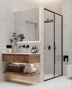 a bathroom with a sink, toilet and shower stall