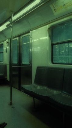 the inside of a subway car with two benches and one bench on the other side