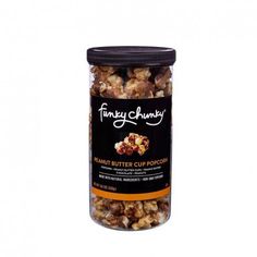 the funky chunk peanut butter cup popcorn in a glass jar with black lid and brown sugar coating