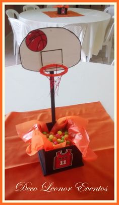 an orange table cloth with a basket and basketball on it