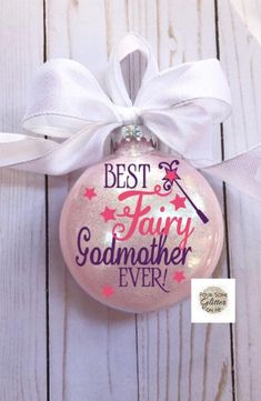 a pink ornament with the words best and fairy godmoter ever on it