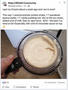 a person holding a blender with cream in it