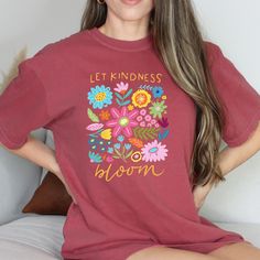 Spread kindness wherever you go with our Let Kindness Bloom T-Shirt! Featuring a beautiful floral and abstract design, this shirt is a reminder to always let kindness bloom in your heart and actions. Comfortable and stylish, it's the perfect addition to your wardrobe. Inspirational Short Sleeve Tops For Spring, Inspirational Relaxed Fit T-shirt For Spring, Bohemian Spring T-shirt With Graphic Print, Spring Bohemian T-shirt With Graphic Print, Spring Heart Print T-shirt, Spring Heart Graphic T-shirt, Red Floral Print Cotton T-shirt, Valentine's Day Graphic Print Short Sleeve T-shirt, Spread Kindness