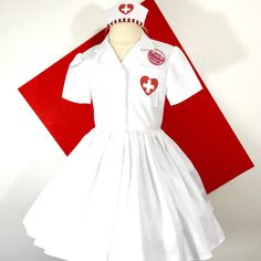 White Nurses uniform shirt Dress with heart cross pocket detail and hat. This dress is shown with an underskirt that can be purchased in my shop for an additional $10. https://www.etsy.com/listing/116097306/tulle-underskirt-made-to-order?ref=shop_home_active Thank you for checking out my listing! Fitted Short Sleeve Dress For School, Fitted Short Sleeve School Uniform Dresses, Cotton Nursing Friendly Dress, White Cotton School Dress, White Cotton Dresses For School, Cotton Short Sleeve Dress For Costume Party, Fitted Cotton Costume Dress, White Short Sleeve Costume Dress, White Cotton Costume Dress