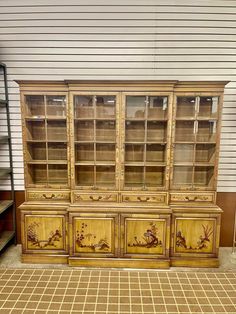 an old china cabinet with painted flowers on it