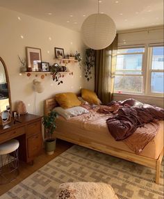 a bedroom with a bed, dresser and mirror