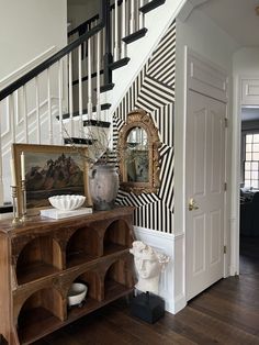 an entryway with black and white striped walls