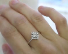 a woman's hand with a diamond ring on it