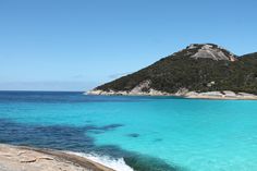 an island in the middle of blue water