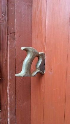 a door handle on a red wooden door