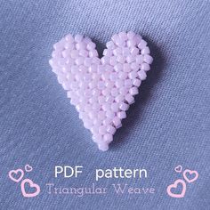 a heart made out of small beads on a blue background with the words pdf pattern triangular weave