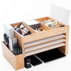 a wooden desk organizer filled with office supplies