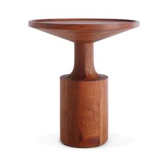 a wooden table with a circular top on it's pedestal, against a white background