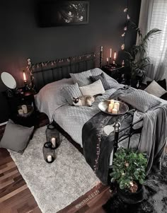 a bed room with a neatly made bed and candles