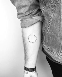 a man with a small tattoo on his arm