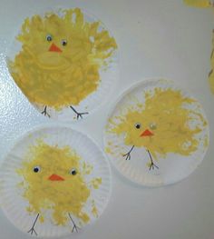 three paper plates with yellow chicks painted on them