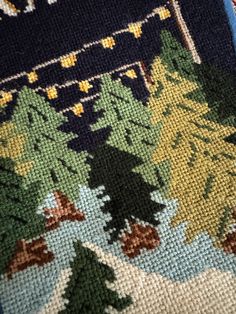 a close up of a rug with trees on it