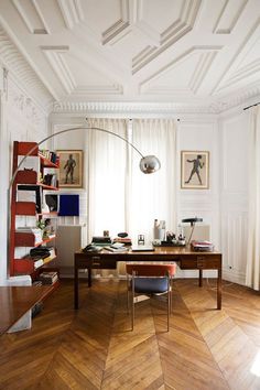 a room with a desk, chair and bookshelf