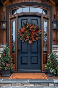 a blue front door decorated with pine cones and wreaths