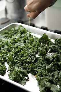 a person is cooking greens in a pan