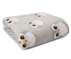 two blankets with an owl design on them, one is grey and the other has orange eyes