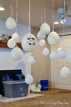 some white balloons are hanging from the ceiling