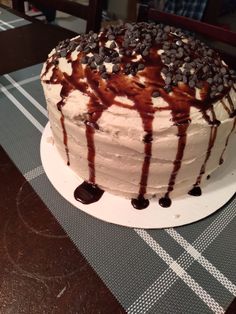 there is a cake with chocolate and oreo cookies on it sitting on the table