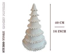 a white crocheted christmas tree is shown with measurements for the top and bottom