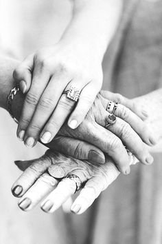 three people holding hands with rings on their fingers