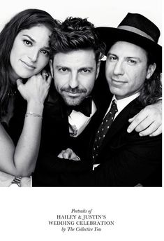 two men and a woman are posing for a photo in front of a white background