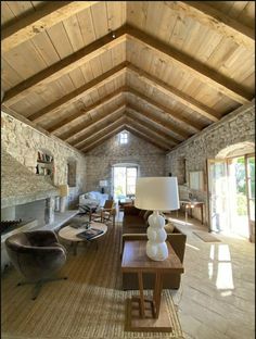 a living room filled with lots of furniture and a fire place in the middle of it