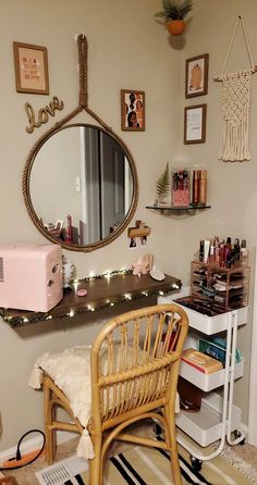 a room with a chair, mirror and other items on the wall above it that is decorated with string lights