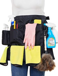 a woman wearing gloves and cleaning products in her pocket, with the back pockets open