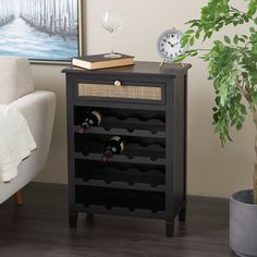 a black cabinet with wine bottles in it and a clock on the table next to it