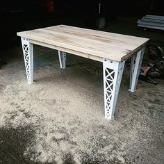 a wooden table sitting on top of a carpeted floor next to a bike rack