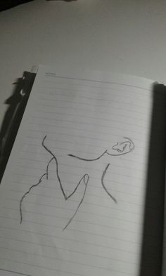 an open notebook with a drawing of a person on it