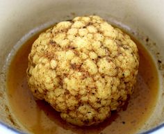 a close up of a food item in a bowl filled with oil and brown liquid