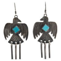 Vintage Native American Navajo Silver and Turquoise Thunderbird Earrings c.1970s Length: 2.45" Width: 1.13" Weight of each earring: 4.86 grams The Thunderbird is a sacred symbol with many meanings. The belief is that the Thunderbird protects them, warns them of approaching danger and nourishes their crops. Like all birds, the Navajo Thunderbird is also a spirit guide. Many Navajo believe the Thunderbird guides the souls of the dead through the underworld. Navajo Earrings, Spirit Guide, The Underworld, Sacred Symbols, All Birds, Vintage Navajo, Underworld, Silver Turquoise, Chandelier Earrings