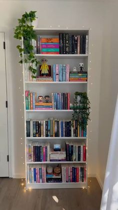 a bookshelf filled with lots of books next to a door