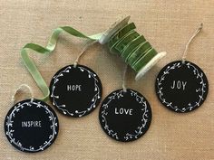 three tags with the words inspire, hope, love and joy hanging from a ribbon