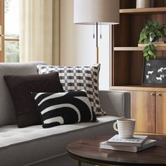 a living room filled with furniture and pillows