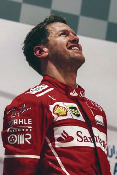 a close up of a person wearing a racing suit