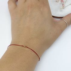 In many cultures, red string bracelets are traditionally used as a symbol of protection, good luck, or blessing. In my native Argentina, red thread bracelets are used to ward off evil spirits. It's very common to see kids and adults wearing a red thread on their wrists at all times. These bracelets are my modern interpretation of a classic good luck charm.  They are simply the perfect little gift for everybody in your list (including you!) These small bracelets may look delicate but they are actually very durable. We use nylon and/or polyester thread so they are super strong and water resistant. Once you put it on, just leave it on! They come ready for gift giving and we will include a little card explaining the meaning of these bracelets. ∙ ∙ ∙ ∙ ∙ ∙ S I Z E S Small (kids 3-7 yrs old): 5" Red Adjustable Friendship Jewelry, Red Adjustable Cord Jewelry For Friendship, Red Adjustable Cord Friendship Jewelry, Red Bracelets With Tiny Beads As Gift, Minimalist Red Friendship Bracelet With Sliding Knot, Red Hypoallergenic Spiritual Bracelet, Dainty Red Friendship Bracelets As Gifts, Dainty Red Friendship Bracelet Gift, Red Adjustable Friendship Bracelets As Gifts